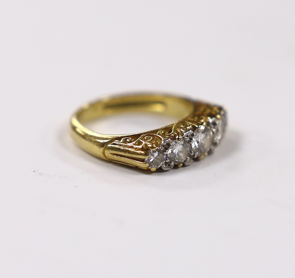 A modern 18ct gold and graduated five stone diamond set half hoop ring, size G, gross weight 5.2 grams.